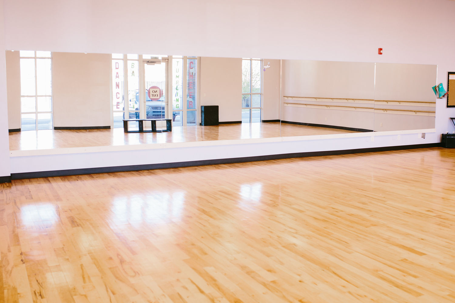 Inside a Project Dance studio room with mirrors and barre